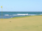 A birdie putt on No. 15 with seabirds and Pacific breakers as a backdrop.