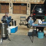 John Cuckler Jr., left, and Peter Odiorne sit and monitor the turkeys as they deep fry — a Thanksgiving tradition at the Mountain Air County Club. 