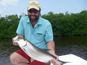 The author holds a "baby" tarpon taken from one of the cenote-fed saltwater lakes near the southern end of the Yucatan Peninsula.