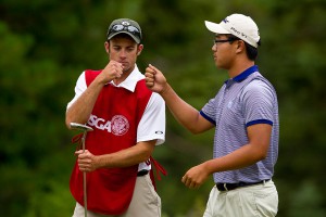 Caddie Eric Hedspeth and Jim Liu fist-bump in the first round of match play, only to hit bigger bumps in round two.
