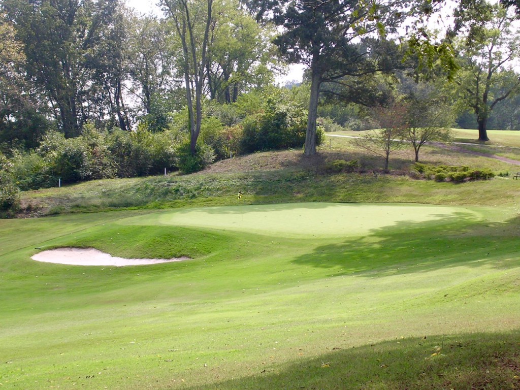 The small green at the par-3 14th, cut into the bank of a shady glade, is one of the swiftest and most tilted on the course.