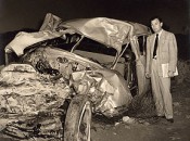 Hogan standing next to what remains of his car after the February 1949 accident.