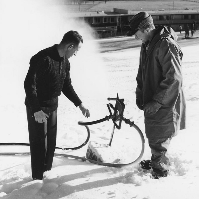 Everett Kircher (keft) testing out an early 1950s snowmaker
