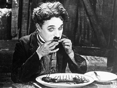 The Tramp munching on his boot in "The Gold Rush"