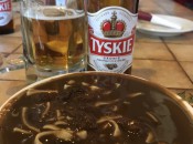 Czarnina, a Polish sweet-sour soup, washed down with a Tyskie beer.