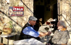 Under the original "Itala Pilsen" sign, Michael Patrick Shiels sits with Lorenzo Motta at Bar Vitelli's.