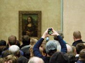 Mona Lisa smiles at the lines of casual art tourists corralled in the Louvre. (Photo by Harrison Shiels)