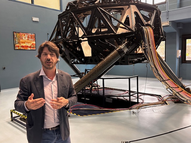 Andrea Vecchi in front of Dallara’s secret, space-age, super car race simulator. Image by Harrison Shiels