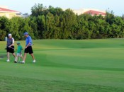 A family threesome leaves the final green on the Lakes 9 at the Moon Spa & Golf Club