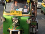 A Thai tuk-tuk takes tourists through the streets of Bangkok from the Anantara Siam Hotel.