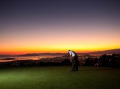 Berkeley Country Club's putting green at dusk, with the San Francisco Bay lit by the setting sun.