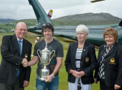 A relaxed Rory McIlroy, with U.S. Open hardware close at hand, is greeted by club officers at Ballyliffin GC.